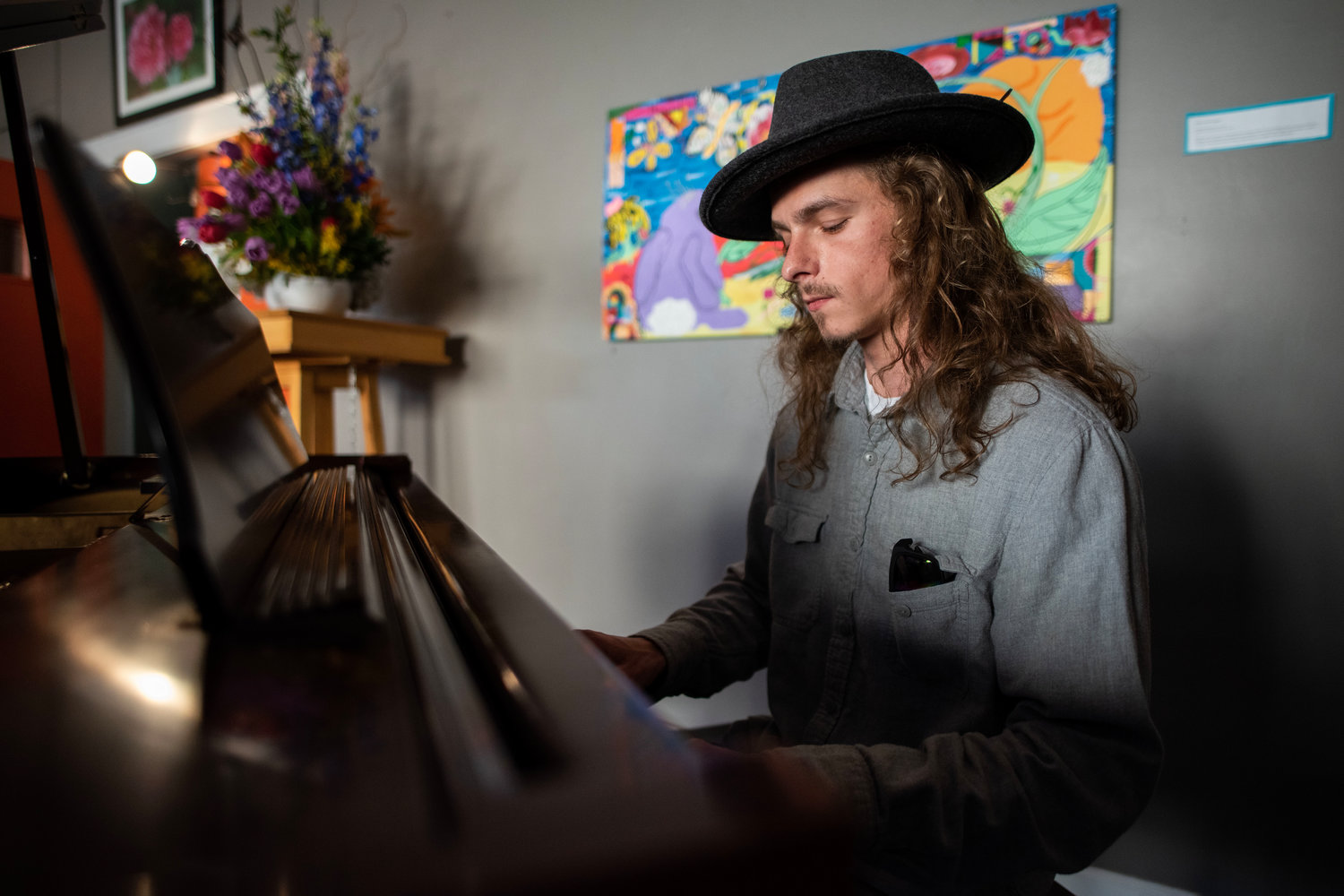 Musician Adam Riersun plays piano during a celebration of Mary John Resch’s life Saturday evening in downtown Siler City.